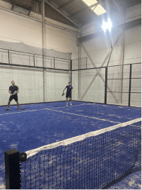 Playing on an indoor padel court